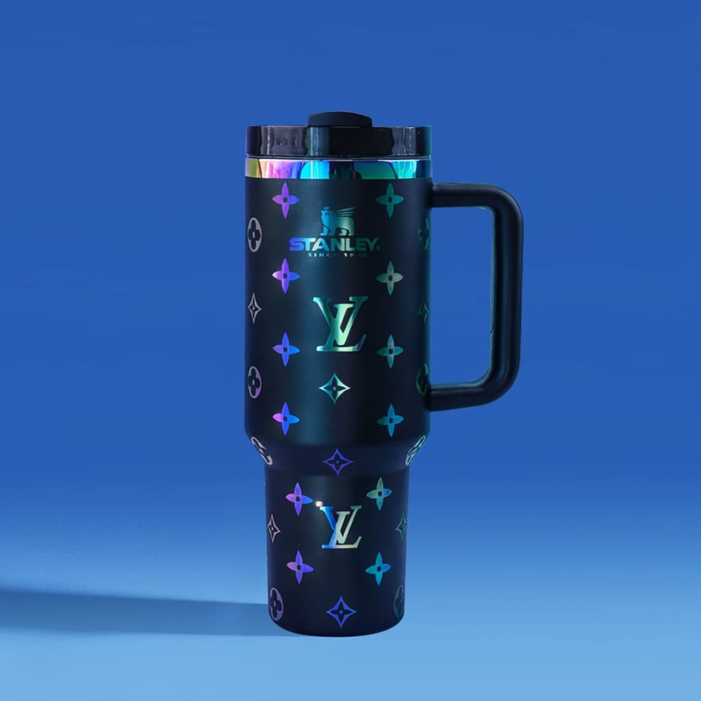Black Stanley travel mug with colorful pattern on a blue background