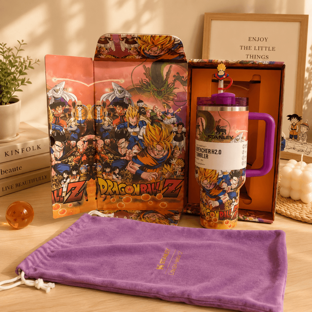 Dragon Ball Z-themed product set including a plush, mug, and pouch on a wooden surface.