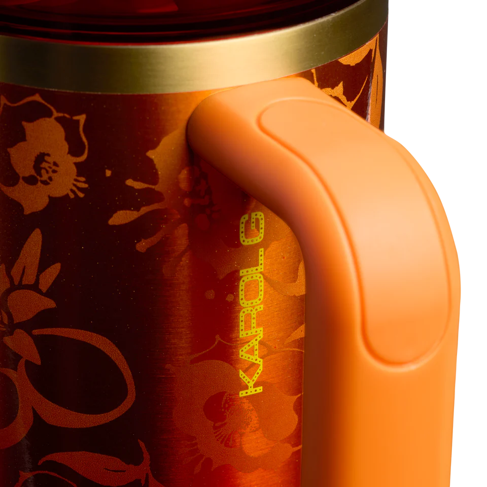 Close-up of an orange thermos with floral design and 'Kambrook' branding.