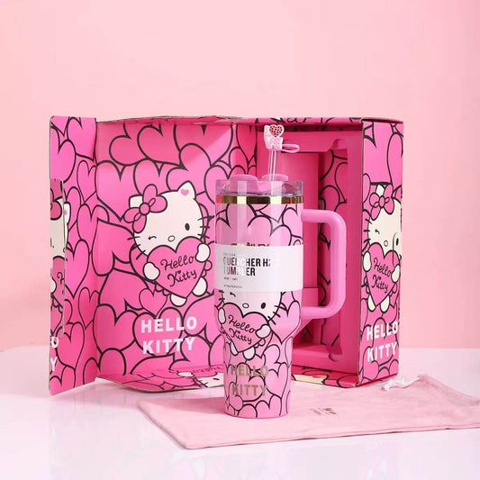 Pink 'Hello Kitty' mug with handle and straw in a matching pink box on a light pink background