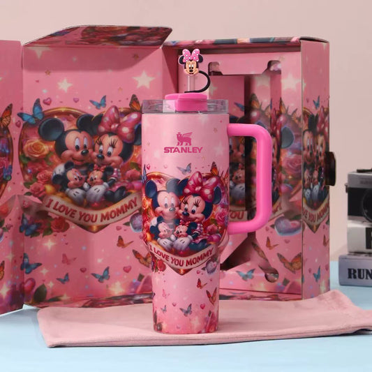 Pink Stanley tumbler with Minnie Mouse design in front of a colorful box