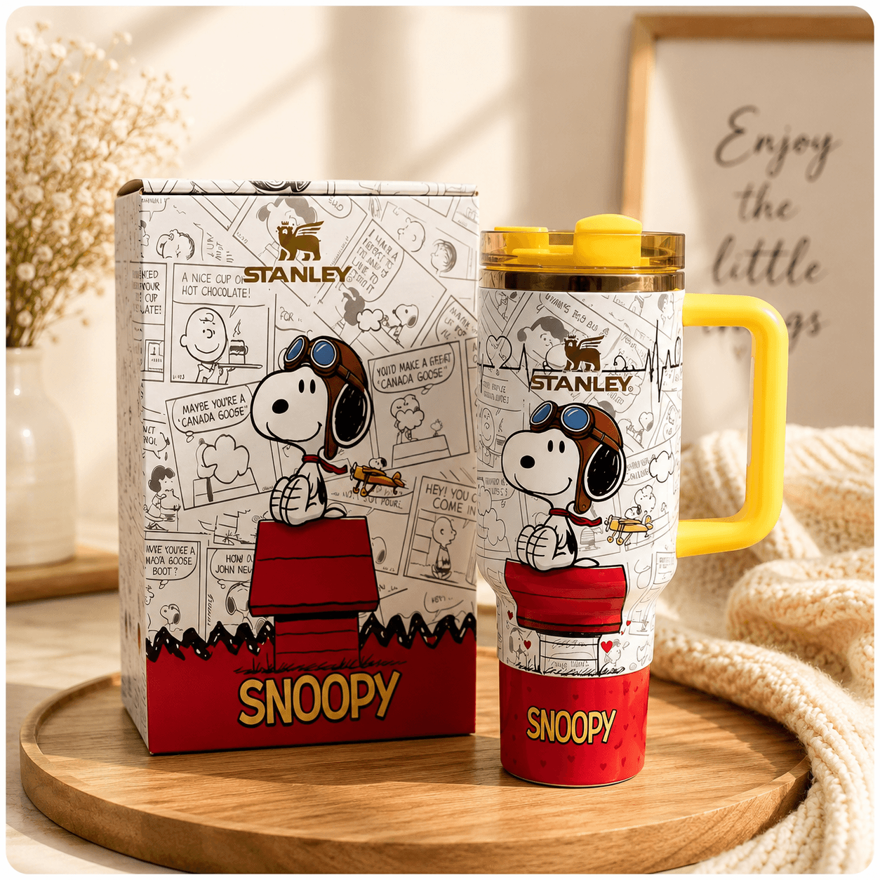 Stanley Snoopy mug with packaging on a wooden surface