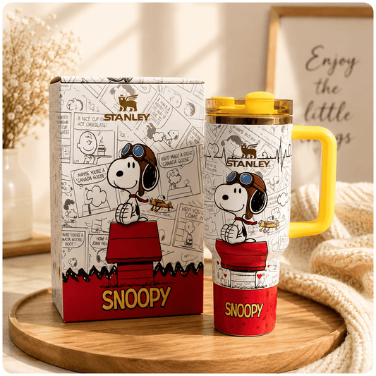 Stanley Snoopy mug with packaging on a wooden surface