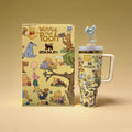 Winnie the Pooh-themed Stanley mug and notebook on a beige background