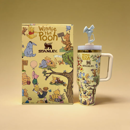 Winnie the Pooh-themed Stanley mug and notebook on a beige background